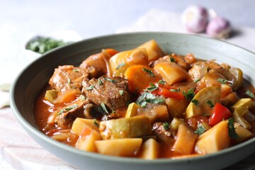 Delicious stew with vegetables in bowl on table, closeup