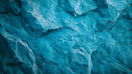Fototapeta premium A tight shot of a blue rock wall with a soaring plane in the mid-sky