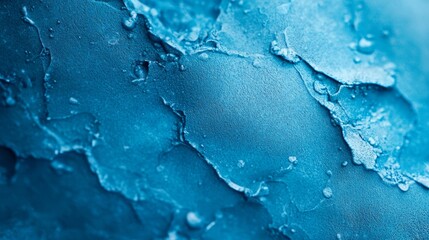 Obraz premium A tight shot of blue paint with water drops on its surface