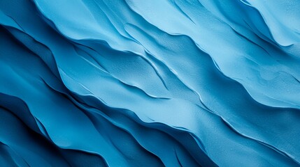  A tight shot of a blue wall adorned with wavy, undulating lines of curved blue paint