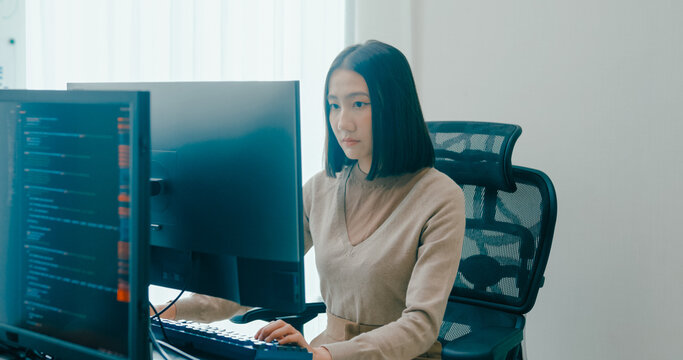 Young adult Asia female freelance typing write prompt AI bot IT app smart program nomad, video game, terminal with coding language, user interface, designer, big data center on desktop computer.