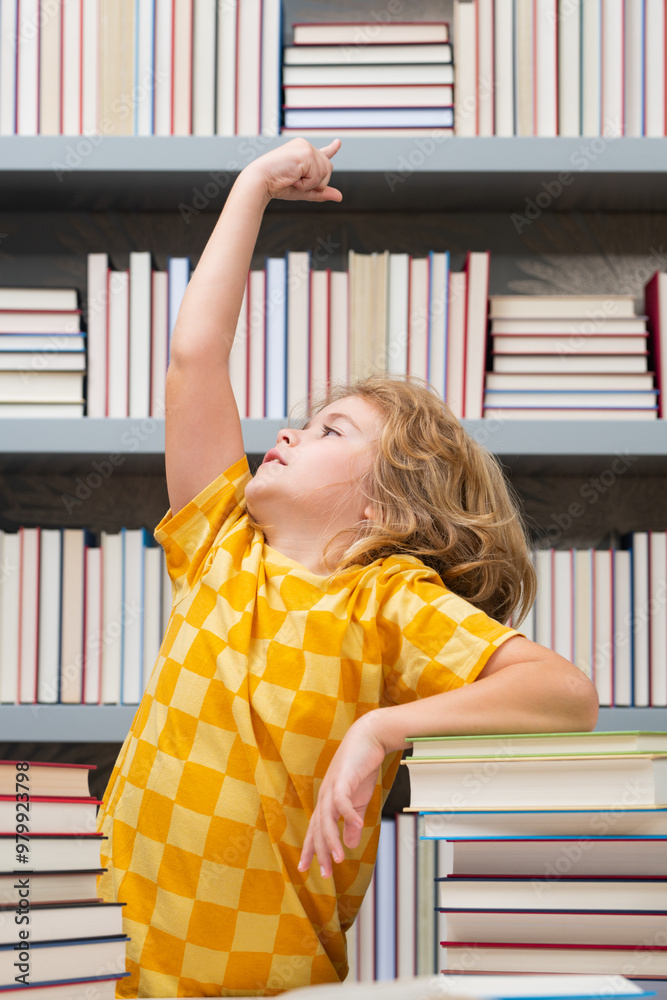 Poster Idea. Elementary schoolboy. Knowledge and education school concept. School boy pupil reading book in library. Kids learn to read. Child reading books in a book store.