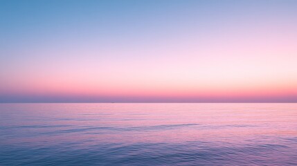 Pastel Hued Sunrise Over Tranquil Seascape with Reflective Surface