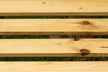 Close-up of wooden boards with natural grain, showcasing their texture and color. Ideal for construction and natural material concepts.