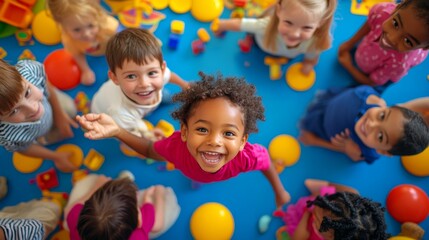 Young children of various backgrounds happily interact while playing with toys on a bright, colorful playmat in an inviting indoor environment filled with joy
