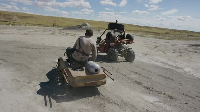 Cinematic shot of warrior jumping onto another mans kart, dangerous stunt