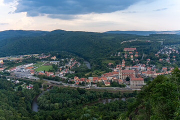 Aerial view of a small beautiful European town set in a valley with a river and historic architecture. Concept of peaceful living, natural beauty and heritage. High quality illustration . High quality
