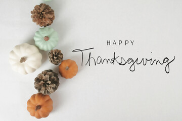 Minimal modern Thanksgiving background with greeting for holiday, flat lay of rustic fall season decorative elements.