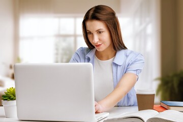 Happy business woman writing in laptop online education.