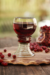 A glass cup of medicinal wine prepared from fresh hawthorn berries