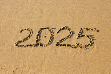 2025 number on a sand beach. Abstract background photo of coming New Year 2025.