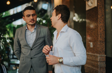 Two business professionals engaging in a conversation about sales strategies and marketing growth in a relaxed setting, showcasing teamwork and business insights.