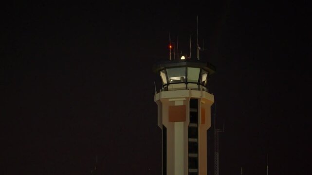 airport control tower at night, lantern light illuminating at night