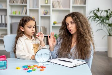 Child and doctor working on articulation and looking contented and concentrated