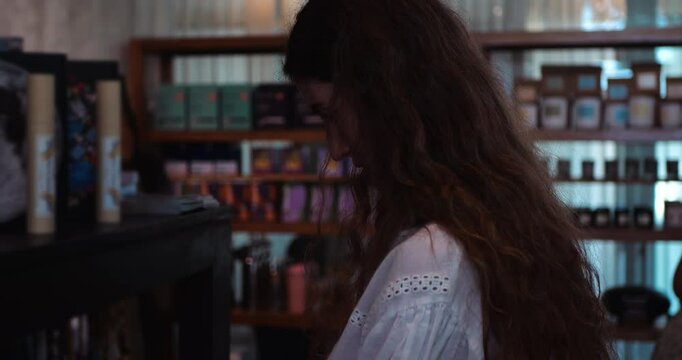 A Beautiful Caucasian Woman Browsing and Selecting Items in a Store.