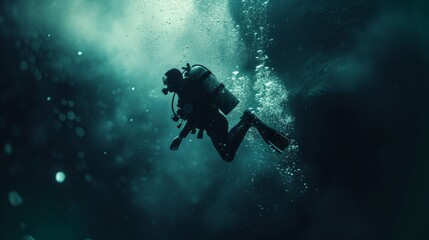 A man in a black wet suit is diving underwater