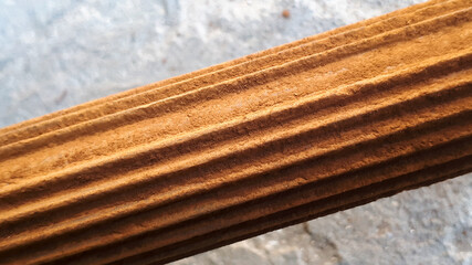 Close-up of a textured wooden surface, showcasing rich earthy tones and detailed grooves, ideal for backgrounds and organic designs.