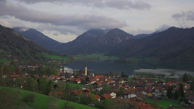 View of mountains and mountain lake in summer. Beautiful town of Schliersee in Bavaria, Germany, Europe. Lake Schliersee in bavarian mountain range. Upper Bayern. Panarama auf den Schliersee. 