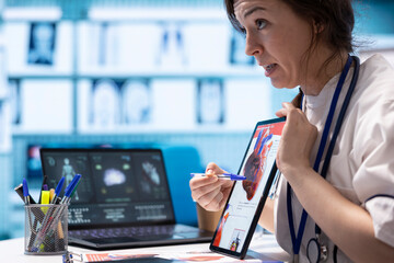 Healthcare provider cardiologist explains heart function on a cardiogram, doctor patient...