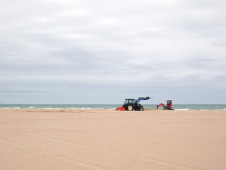Excavators working on the excavation of the sand on the beach.