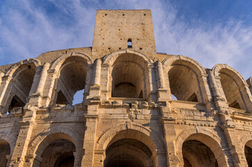 Arles Amphitheatre - A closeup low-angle view of the front facade of the 2,000-years-old Arles Amphitheatre on a sunny Spring evening. Arles, South of France, Europe.