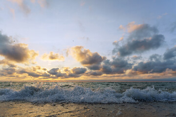 Fototapeta premium Seascape at sunset. Bright sundown on the sea shore. Sunset on the Baltic Sea.