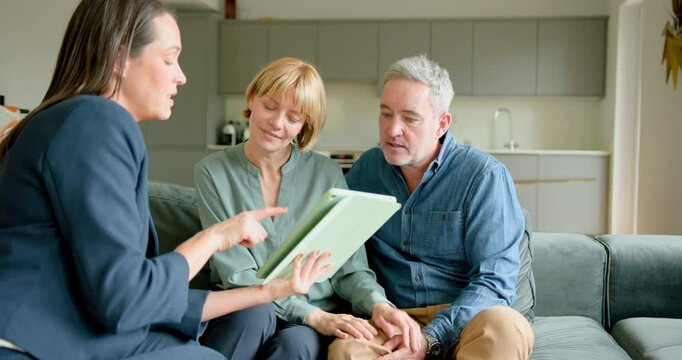 Mature Couple Meeting with Financial advisor, looking at Digital tablet and Handshake