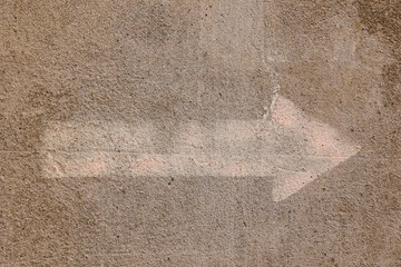 Arrow  on  concrete surface indicating direction