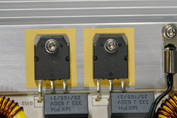 Transistors on an aluminum heatsink.
