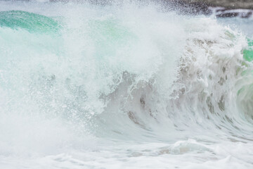 Wave splashing close-up. Crystal clear sea water, in the ocean in San Francisco Bay, blue water pastel colors.