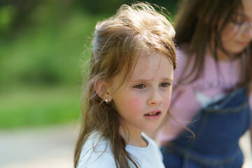 Beautiful smiling children outdoors in summer. Happy childhood concept