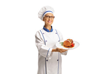 Female chef holding a meat dish on a plate