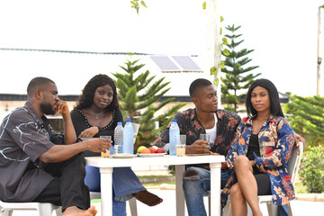 Group of friends enjoying wine and food in back yard