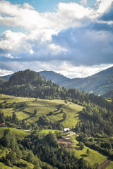 Fototapeta premium Nature's Canvas: Hills and Mountains Beneath a Cloudy Sky