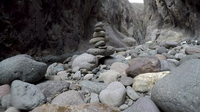 Stones stacked on each other on a riverbed in Somoto Canyon