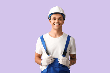 Male car mechanic on lilac background