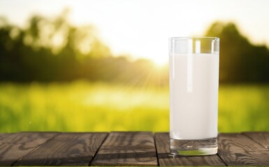 A glass of fresh tasty milk on table