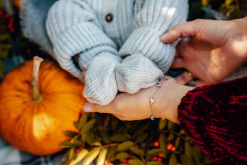 Children's feet in mother's hands in the shape of a heart. Beautiful conceptual image of Motherhood