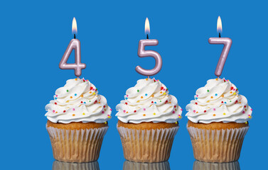 Birthday Cupcakes With Candles Lit Forming The Number 457