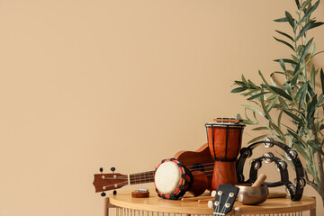 Different musical instruments near beige wall