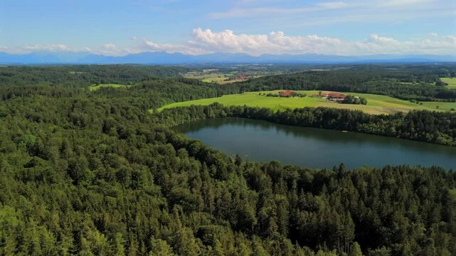 Steinsee bei Munchen Luftaufnahme. Steinsee, See in Bayern Luftbildansicht. Lake Stein aerial view near Munich, Bavaria, Germany. One of warmest lakes in Germany. Steinsee is located in forest area. 
