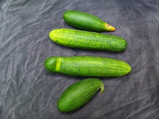 Cucumber vegetable stacked on black background. Cucumber