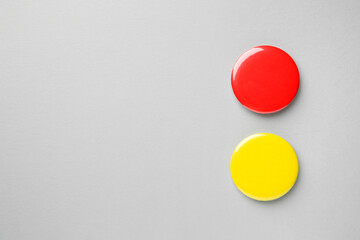 Blank colorful button badges on grey background, top view and space for text. Mockup for design