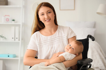 Young mother with her newborn baby in wheelchair at maternity hospital