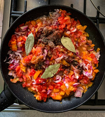 Sizzling Vegetables in a Pan on the Stove