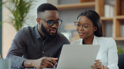 Collaborative teamwork  black technical support specialist assists female coordinator with project