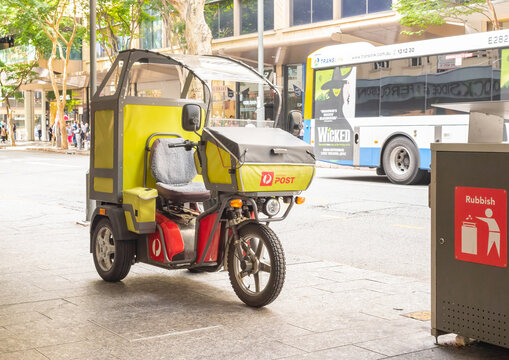 BRISBANE, QUEENSLAND,AUSTRALIA. August 21, 2024. Australia Post electric delivery vehicle, renewable energy, postal worker  parcels and letters.