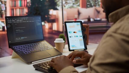 AI software developer creating an algorithm for deep learning and data mining, coding on his laptop...