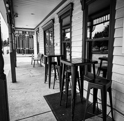 Outdoor Café Seating Area With High Tables And Chairs In Black And White View