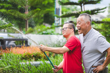 Cheerful grandfather with grandson working in the garden, Senior man and grandson enjoying together...